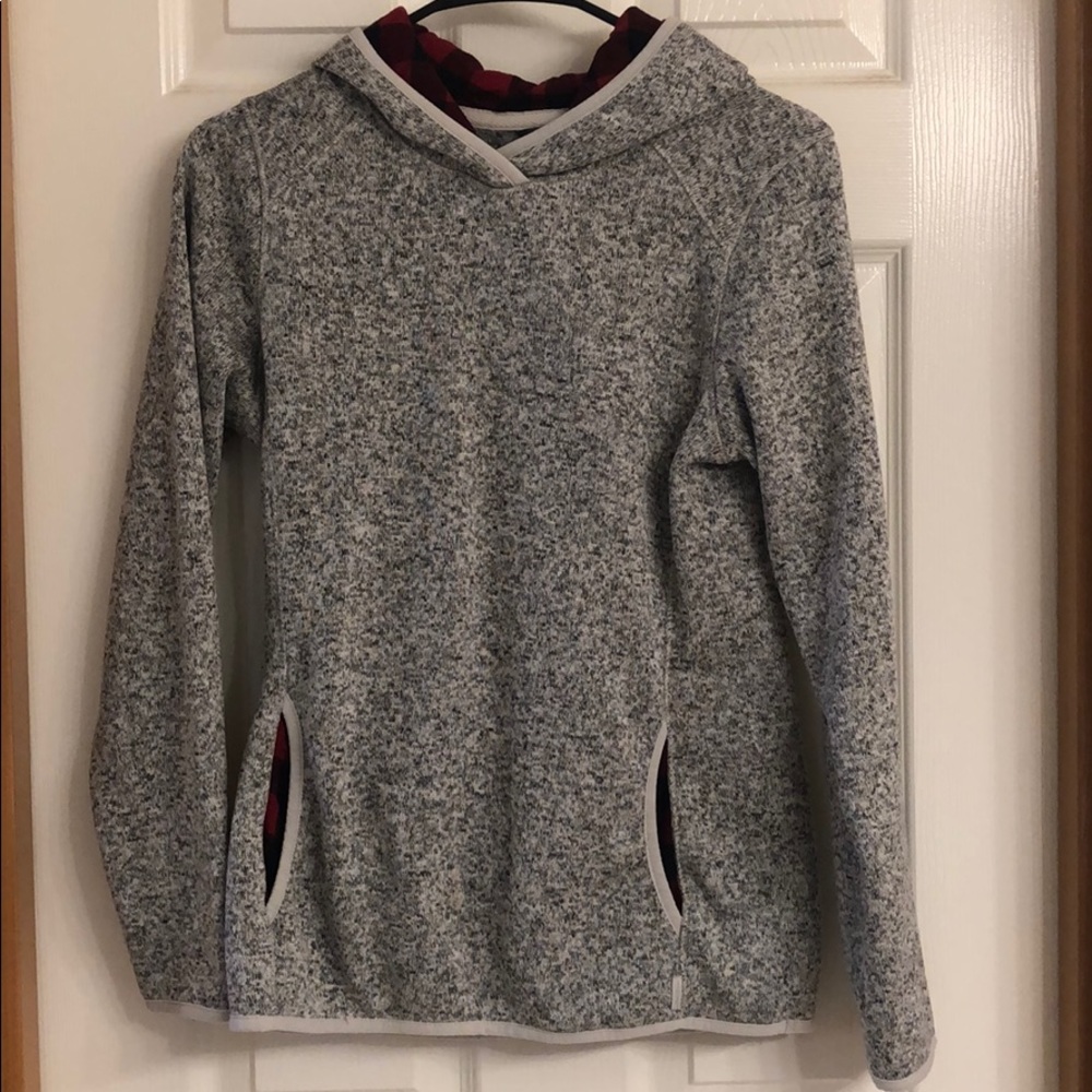 Grey sweatshirt w/ red flannel in pockets/hood.